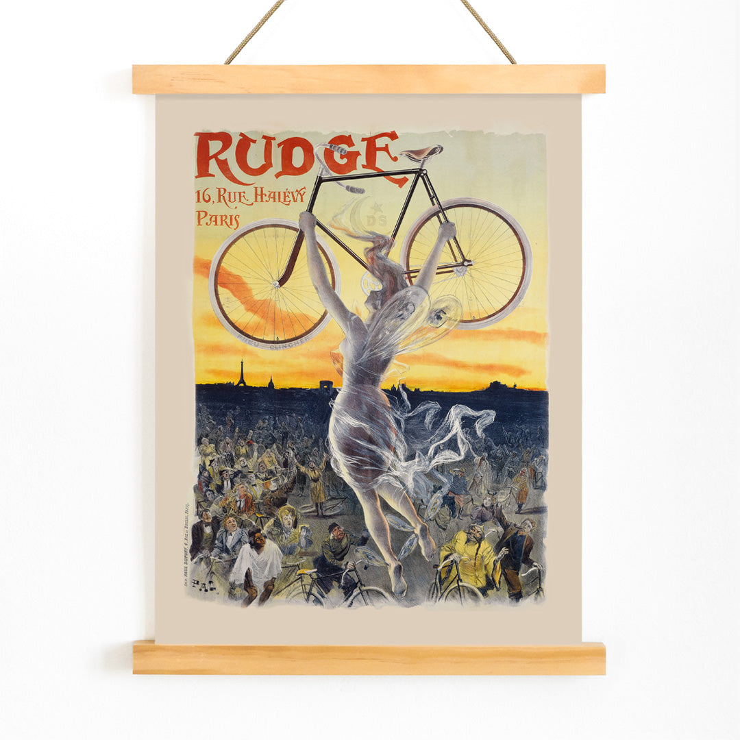Vintage bicycle poster by Jean de Paleologue showing a triumphant figure and a woman holding a bicycle above a crowd at sunset for Rudge bicycle brand, with wooden magnetic frame on white background