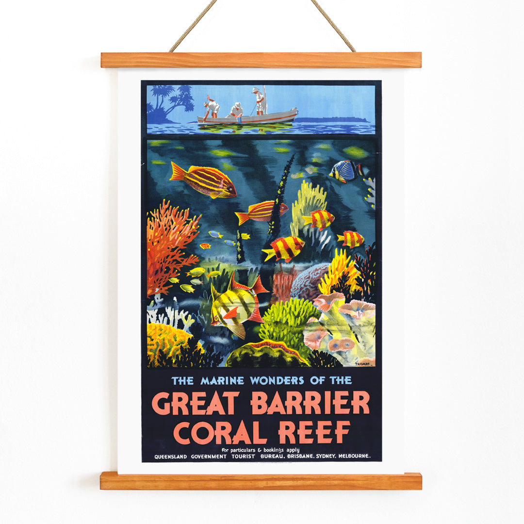 Colorful coral reef and tropical fish with people in a boat above artwork The Marine Wonders of the Great Barrier Coral Reef by Percival Albert Trompf, with wooden magnetic frame on white background