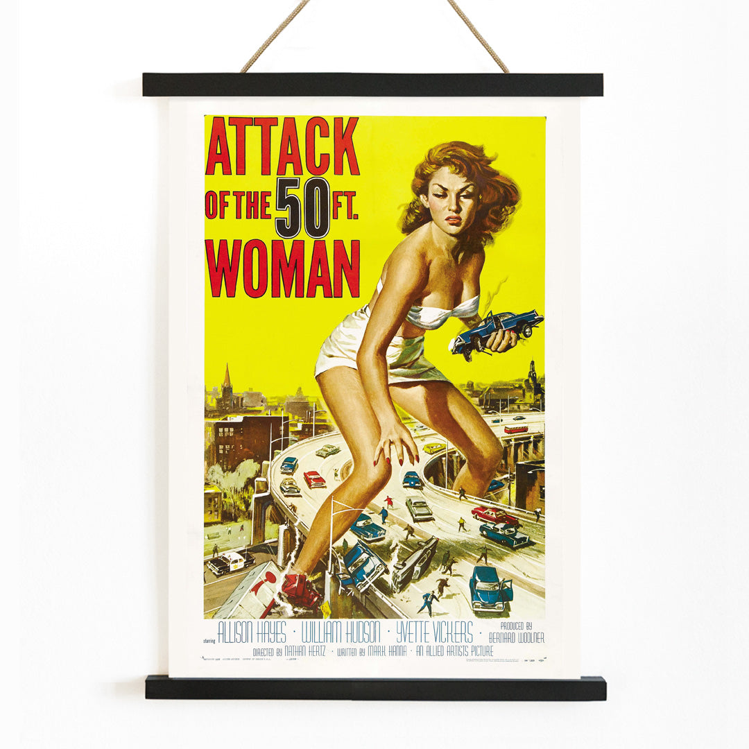 Giant woman towering over city and highway holding cars Attack of the 50ft Woman poster artwork by Reynold Brown, with wooden magnetic frame on white background