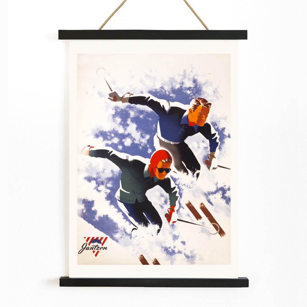 Poster of man and woman skiing down snowy slope artwork by Joseph Binder, with wooden magnetic frame on white background