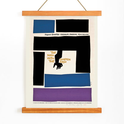Movie poster for The Man with the Golden Arm by Saul Bass featuring bold abstract shapes and a stylized arm and hand in vibrant colors, with wooden magnetic frame on white background