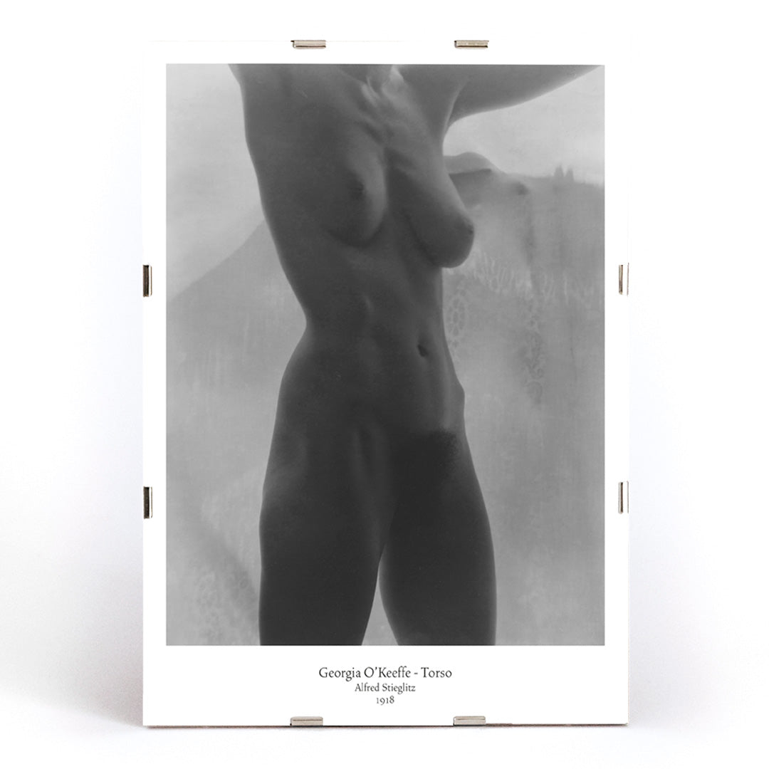 Black and white artistic nude torso photograph of Georgia O Keeffe titled Torso by Alfred Stieglitz poster, framed and displayed in modern living room decor