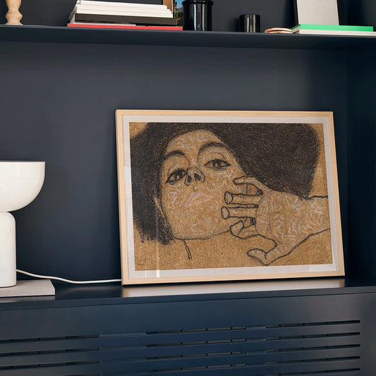 Head of a Woman by Egon Schiele expressive portrait art drawing poster showing a womans face with intricate hand details on a textured background, framed and displayed in home decor