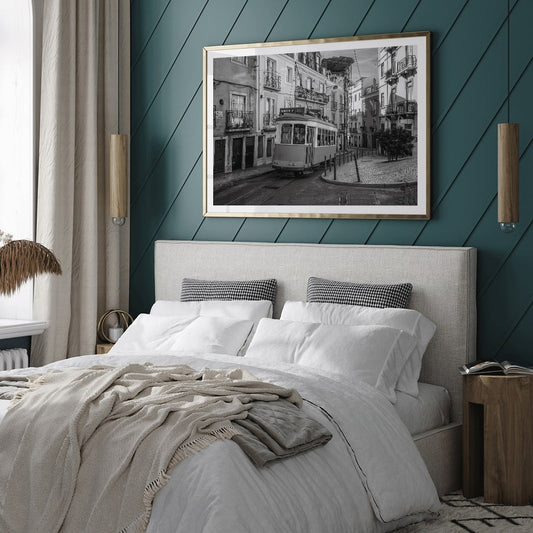 Lisbon Tramway 28 Black and White historic tram navigating cobblestone streets in Lisbon street scene poster, framed and displayed in home decor