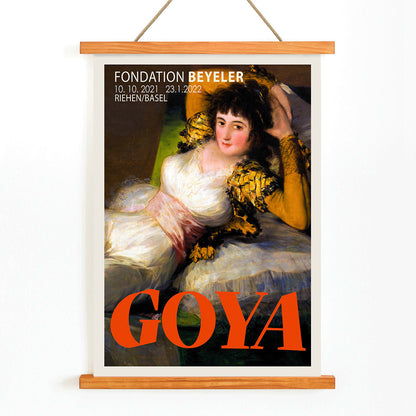 The Clothed Maja exhibition poster by Francisco Goya at Fondation Beyeler showing a reclining woman in a white and gold dress with yellow sleeves, with wooden magnetic frame on white background