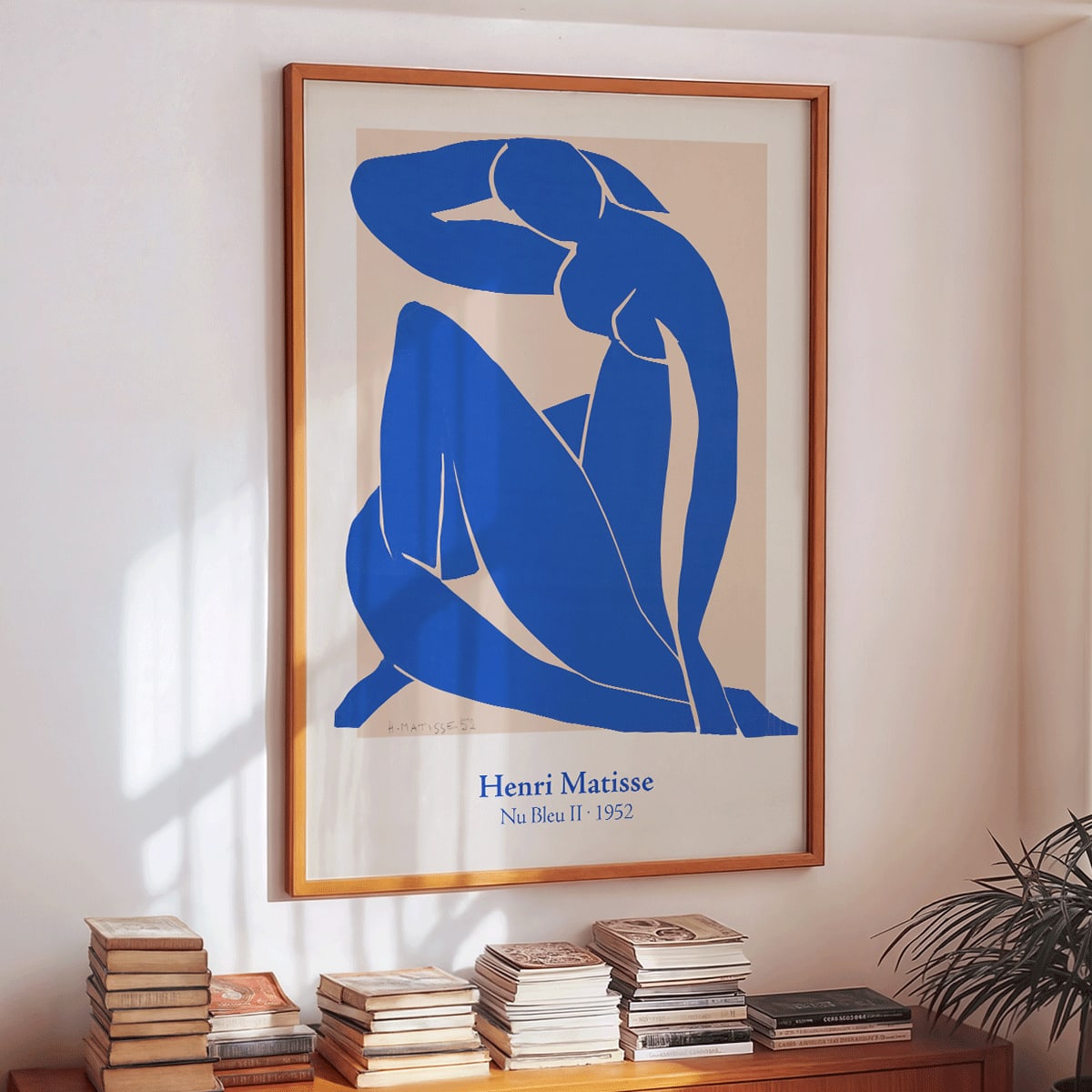 Nu Bleu II by Henri Matisse blue abstract figure art print poster on beige background framed, framed and displayed in home decor