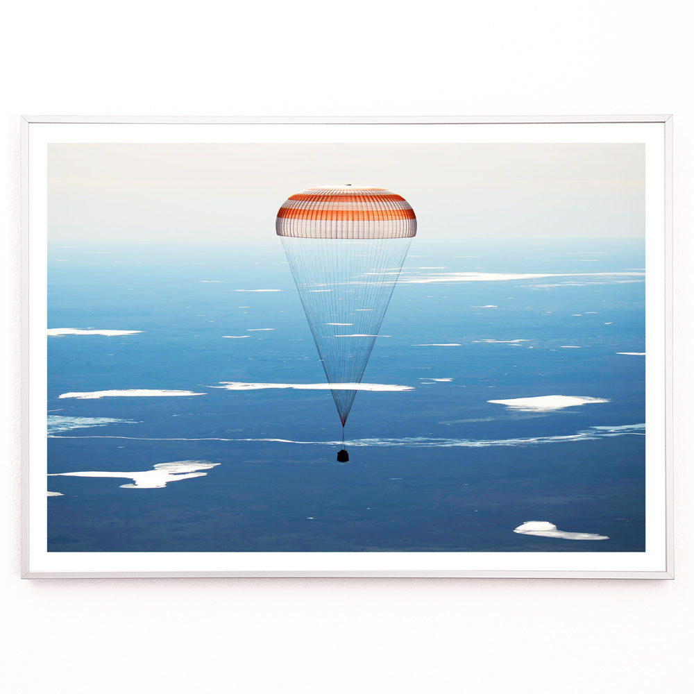 Closeup detail of Soyuz MS-02 spacecraft descending with parachute over Kazakhstan NASA poster artwork showing landing