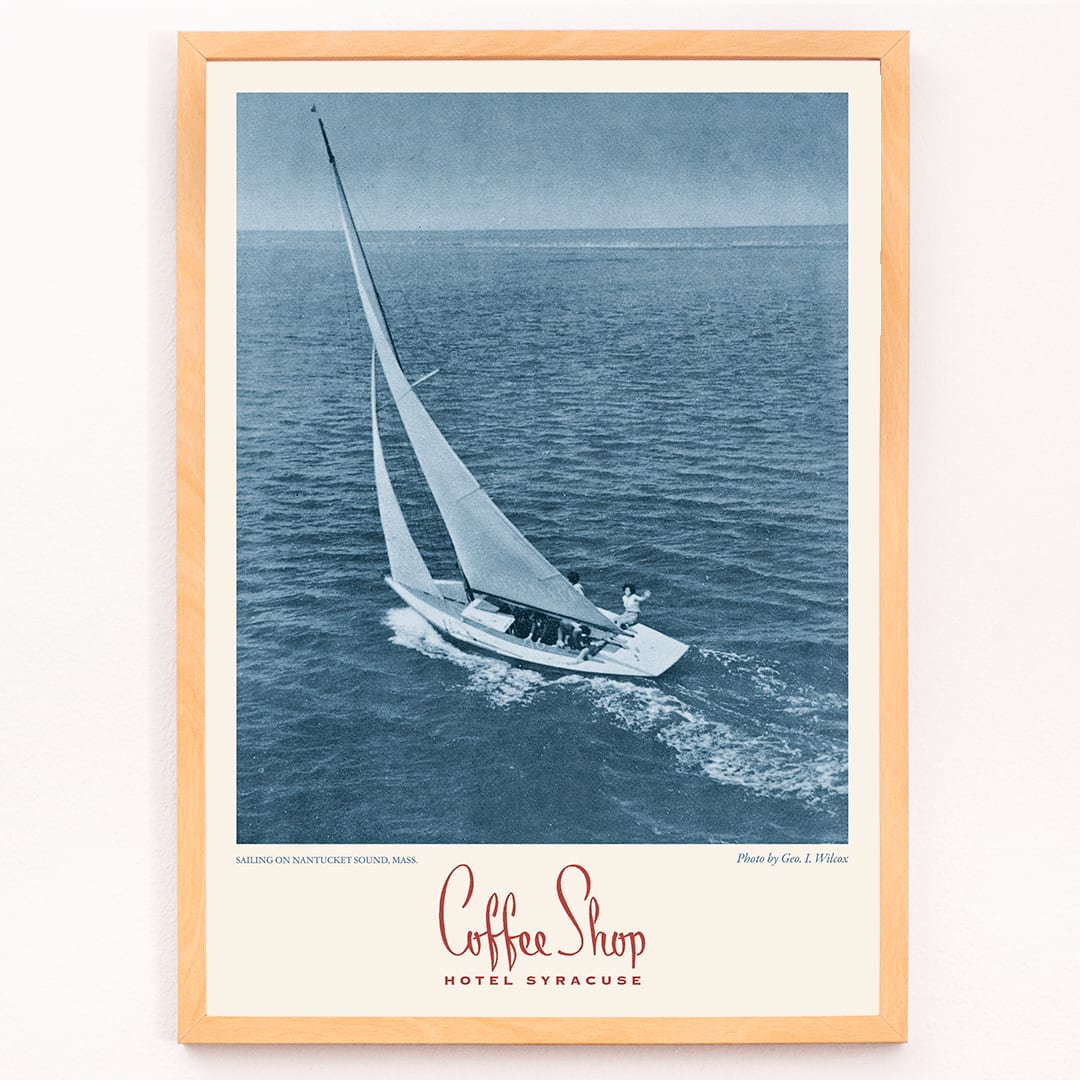 Vintage poster Coffee Shop Hotel Syracuse with sailboat on Nantucket Sound blue-toned photo by Geo I Wilcox, framed and displayed in modern living room decor
