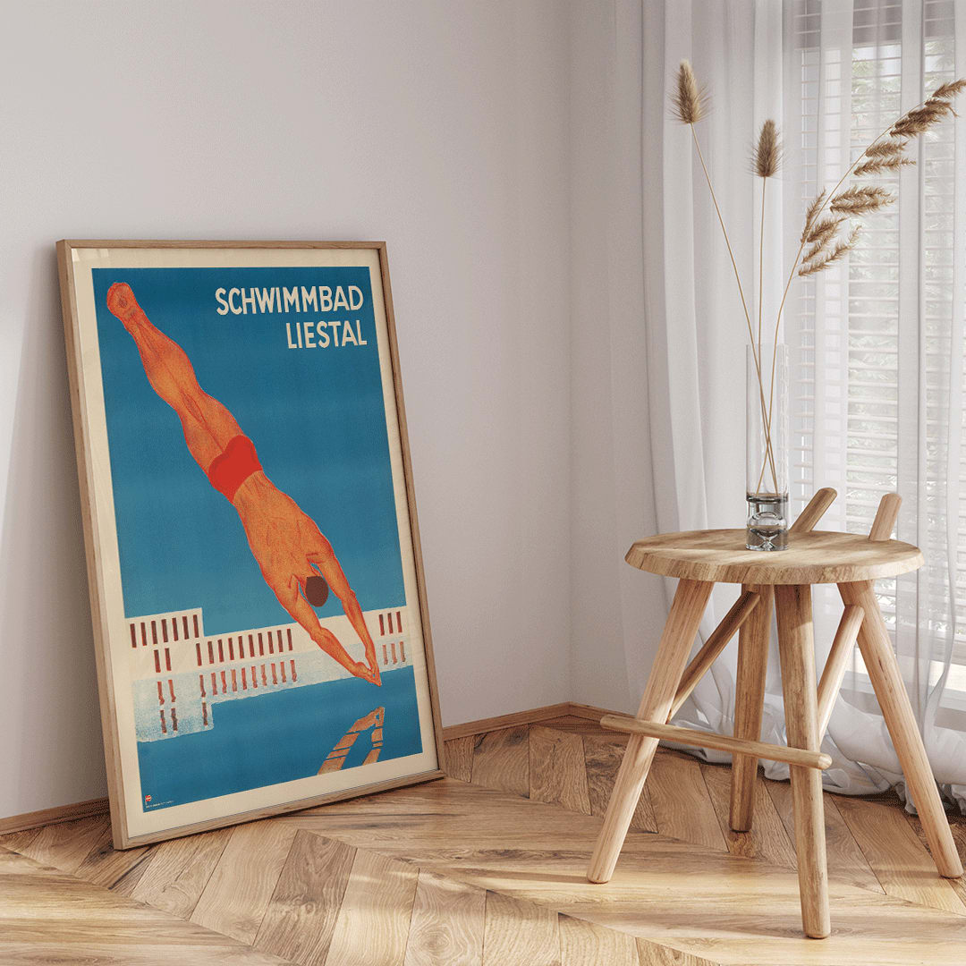 Schwimmbad Liestal poster by artist showing a man diving into a pool with a modern building in the background, framed and displayed in home decor