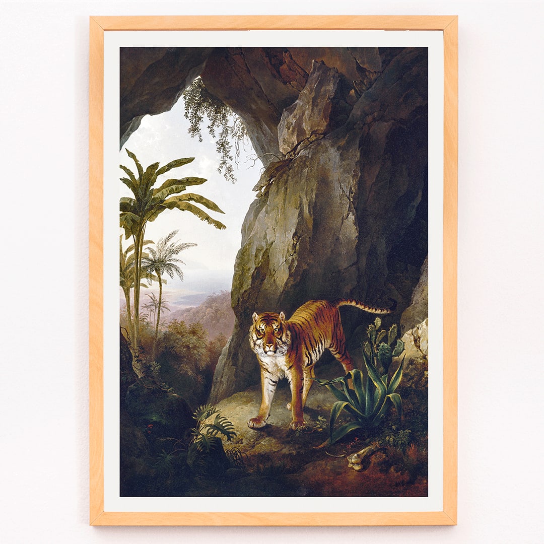 Tiger in a Cave painting by Jacques Laurent Agasse showing a tiger standing in a cave entrance surrounded by lush vegetation, framed and displayed in modern living room decor