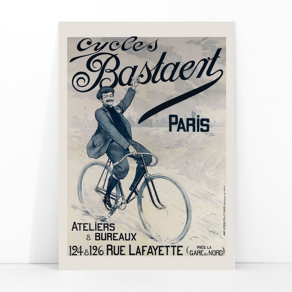 Vintage bicycle poster joyful man riding and waving on Cycles Bastaent Paris bike artwork by Charles Tichon, framed and displayed in modern living room decor
